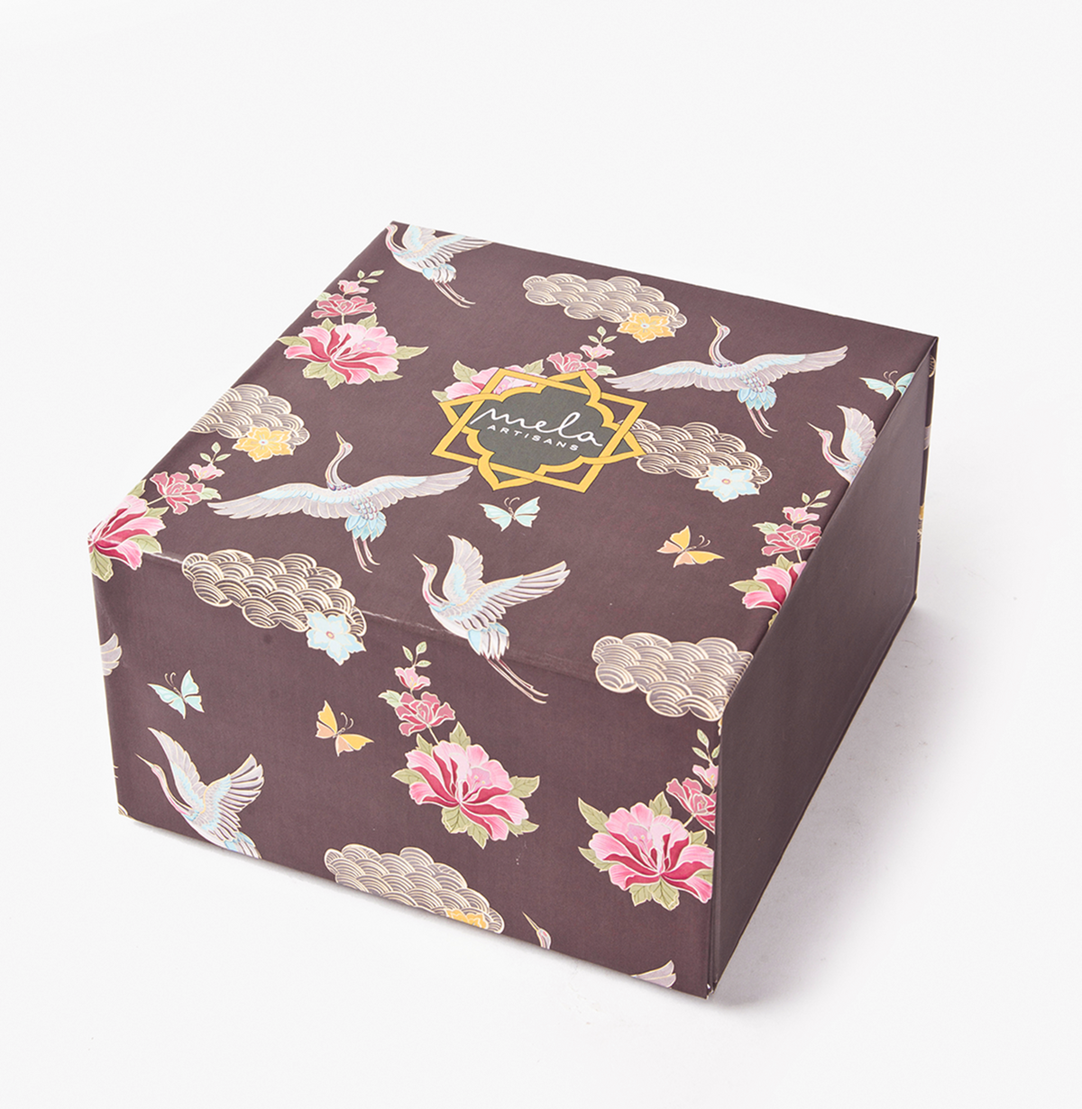 Square decorative gift box in dark brown with floral and crane pattern, “mela” logo