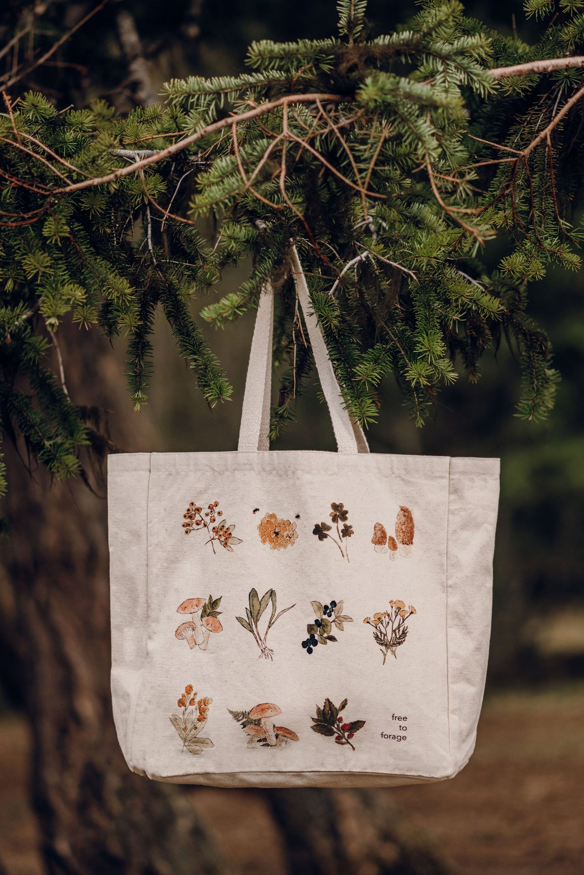 Canvas tote bag with botanical print and long handles, outdoors