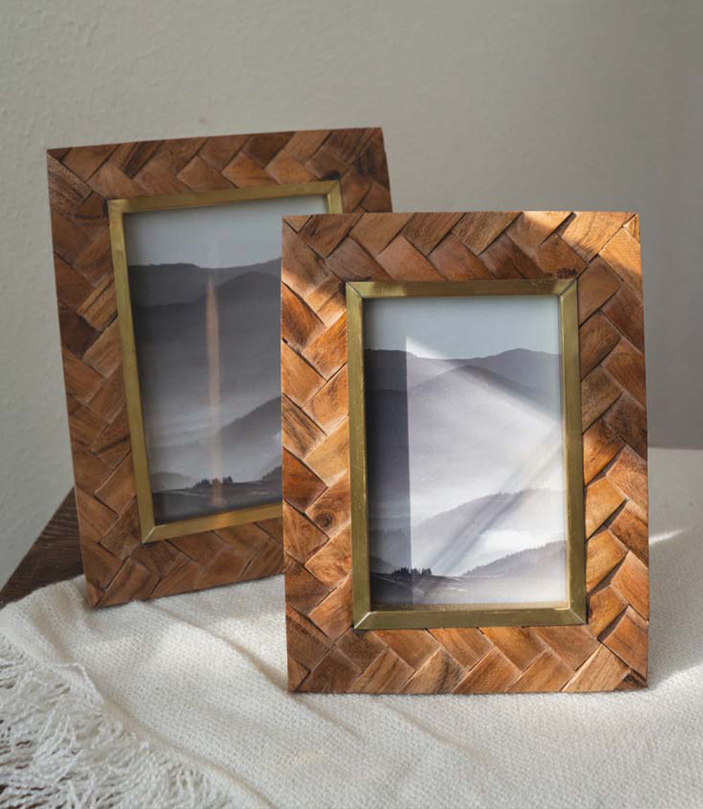 Carved wood picture frame with brass inlay, upright front view with decorative mat