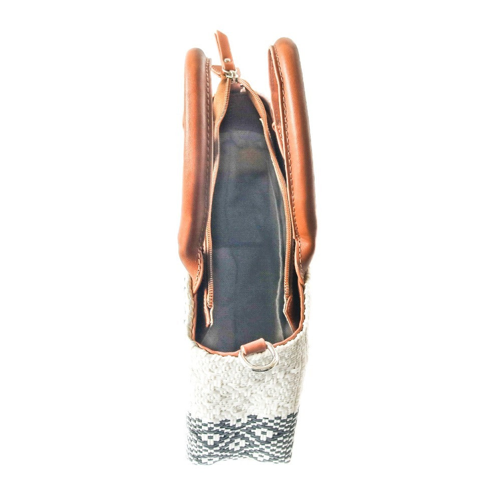 Small woven crossbody bag, tan leather trim, open top shows dark interior lining