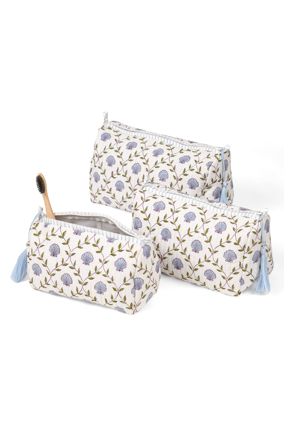 Set of three blockprint makeup bags, white with purple floral medallions, tassel trim