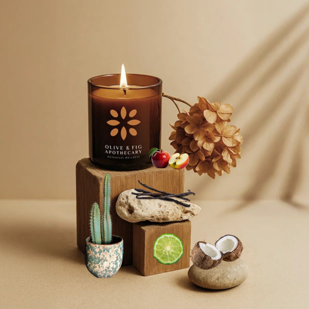 Lit amber glass jar candle with floral logo centered on the front