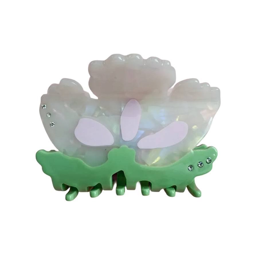 Opalescent floral hair claw with lavender petal accents and green base, rhinestones
