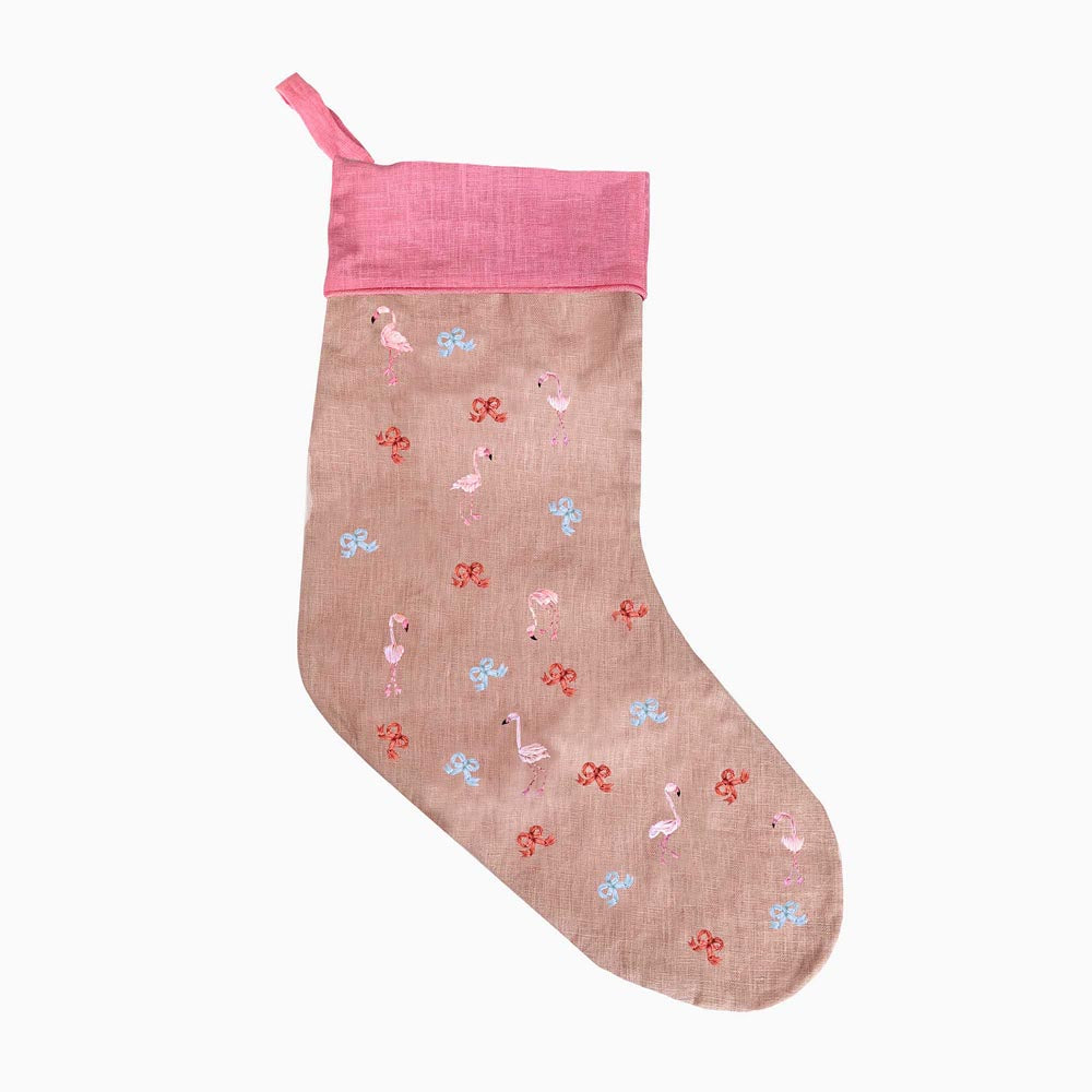 Beige holiday stocking with pink cuff and multicolor flamingo-and-bow embroidery