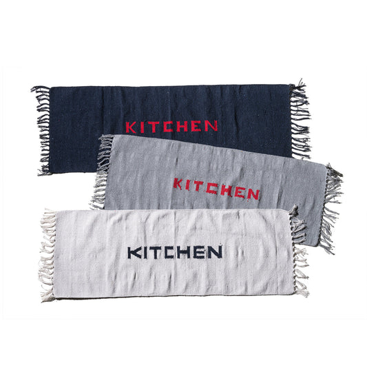 Navy blue kitchen mat with fringe edges and red 'KITCHEN' lettering