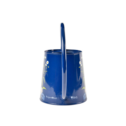 Blue watering can with vertical pour spout and meadow floral artwork around the body.