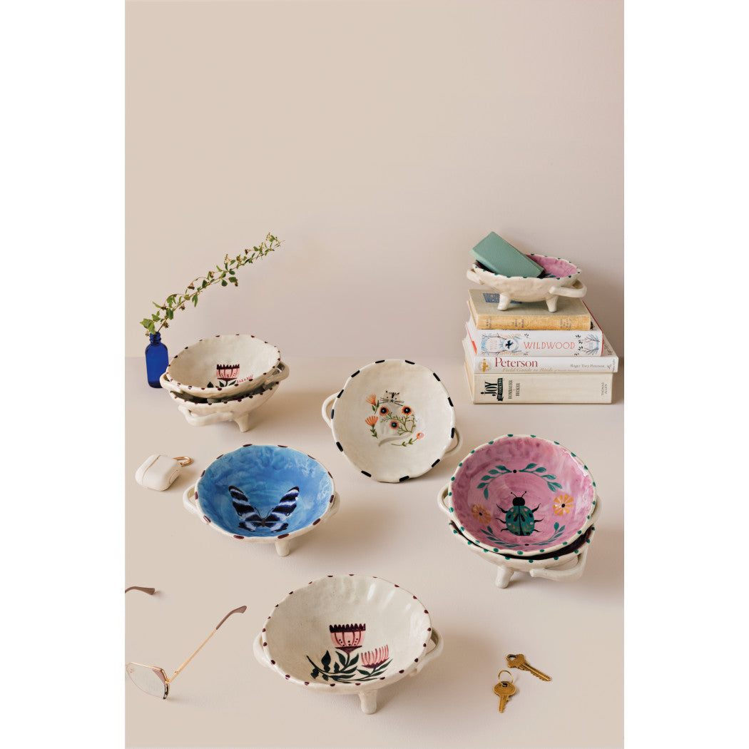 Set of footed bowls with mixed colorful prints and scalloped rims, cream bases.