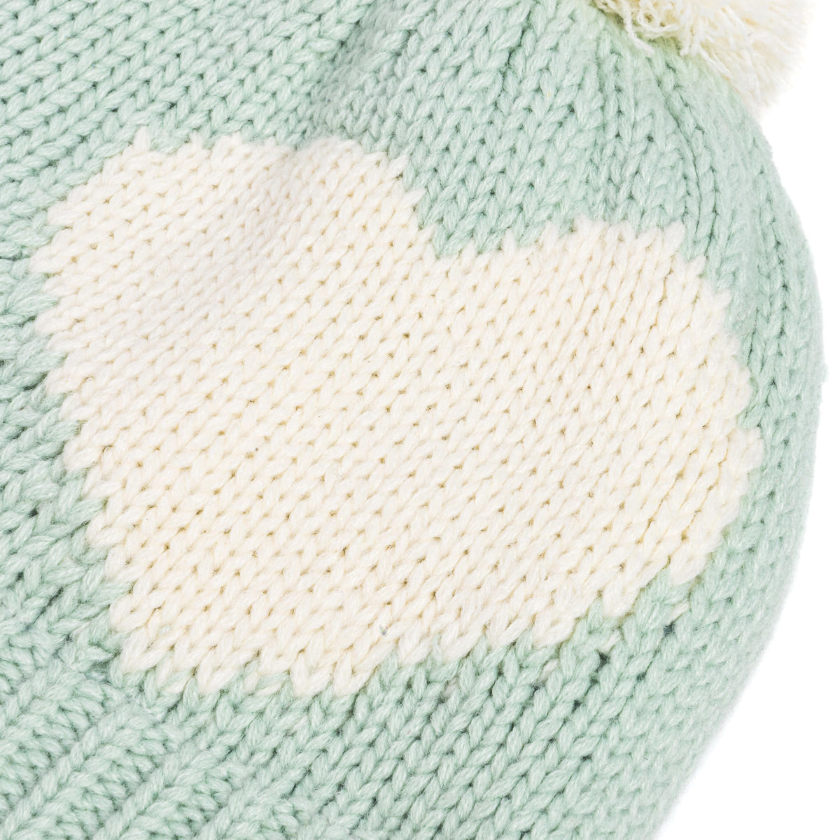 Mint green knit hat with large white heart pattern