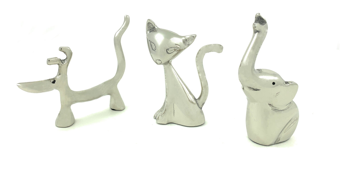 Silver cat-shaped ring holders and a small dog figurine