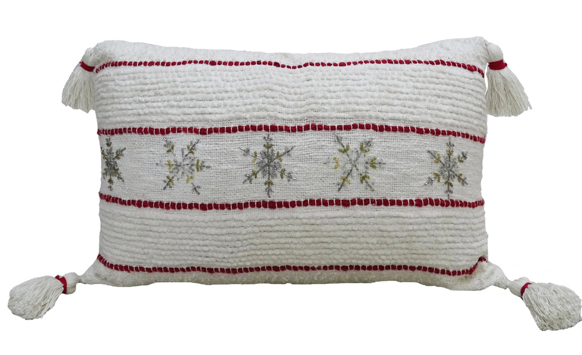 Decorative Christmas pillow with white textured cover, red stripes, snowflake print, and tassels