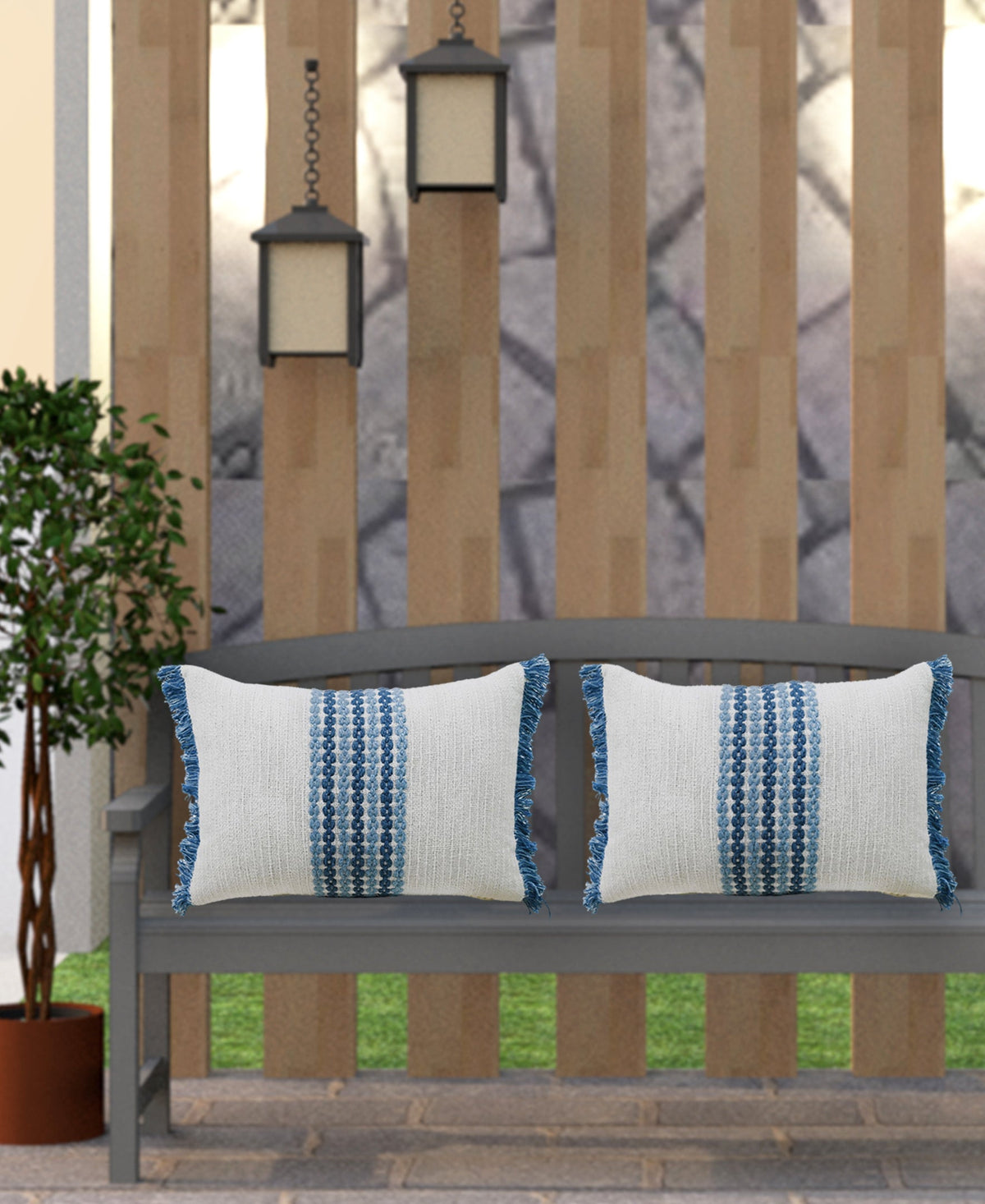 Pair of decorative pillows on bench, off-white covers with blue vertical woven motifs