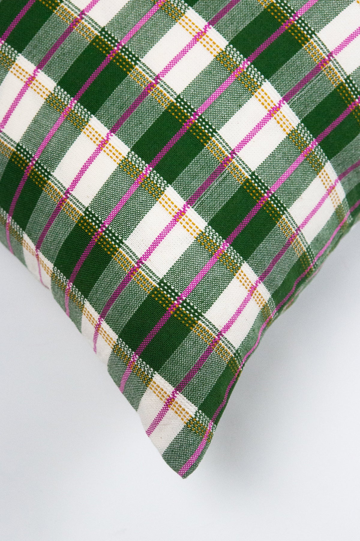Green gingham lumbar pillow corner with multi-color check threads