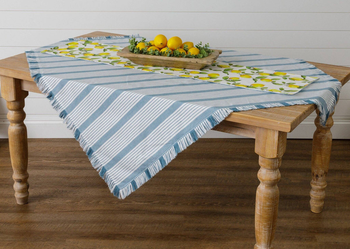 Blue and white striped grain sack tablecloth with fringed edges