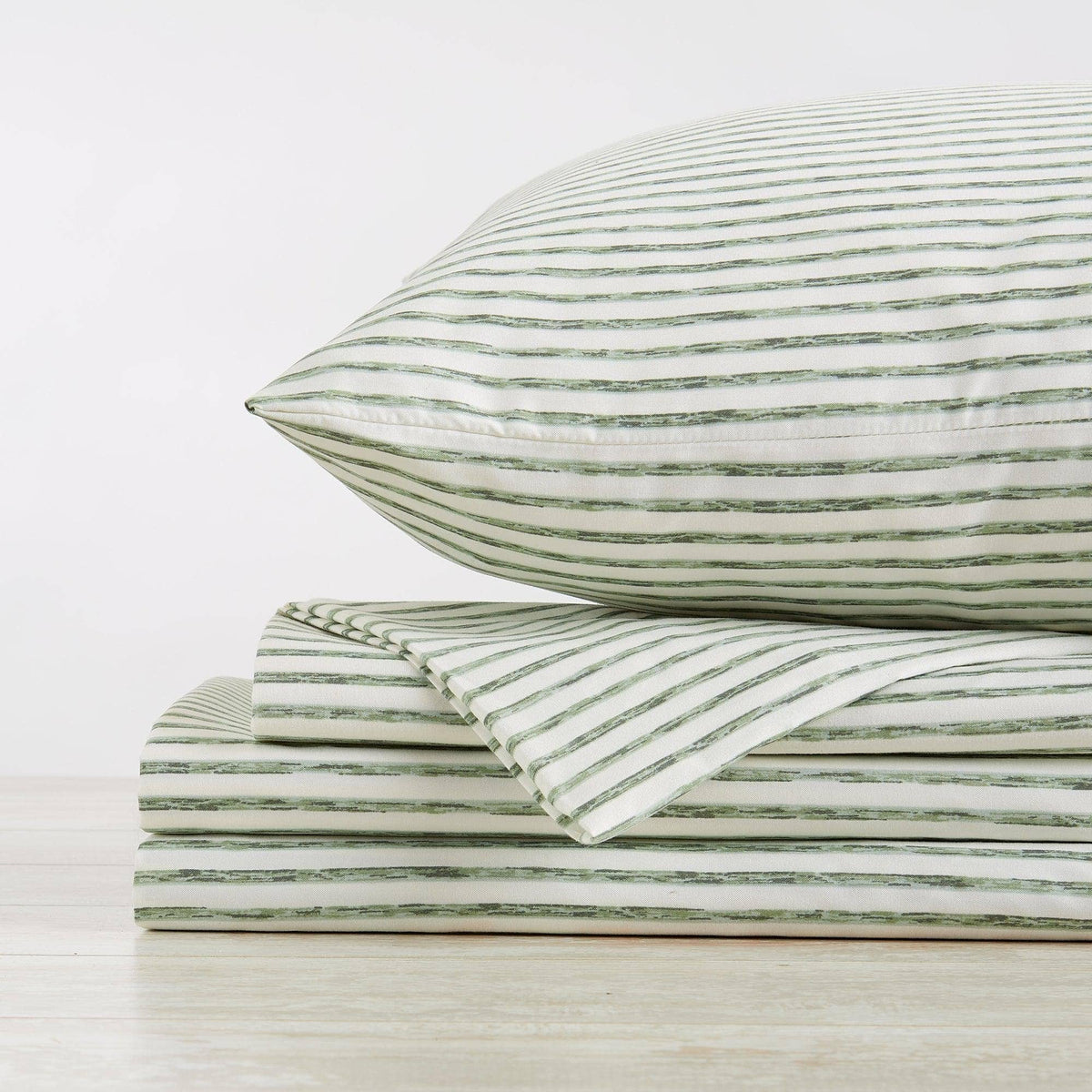 Folded microfiber pillowcases, white fabric with green horizontal stripes