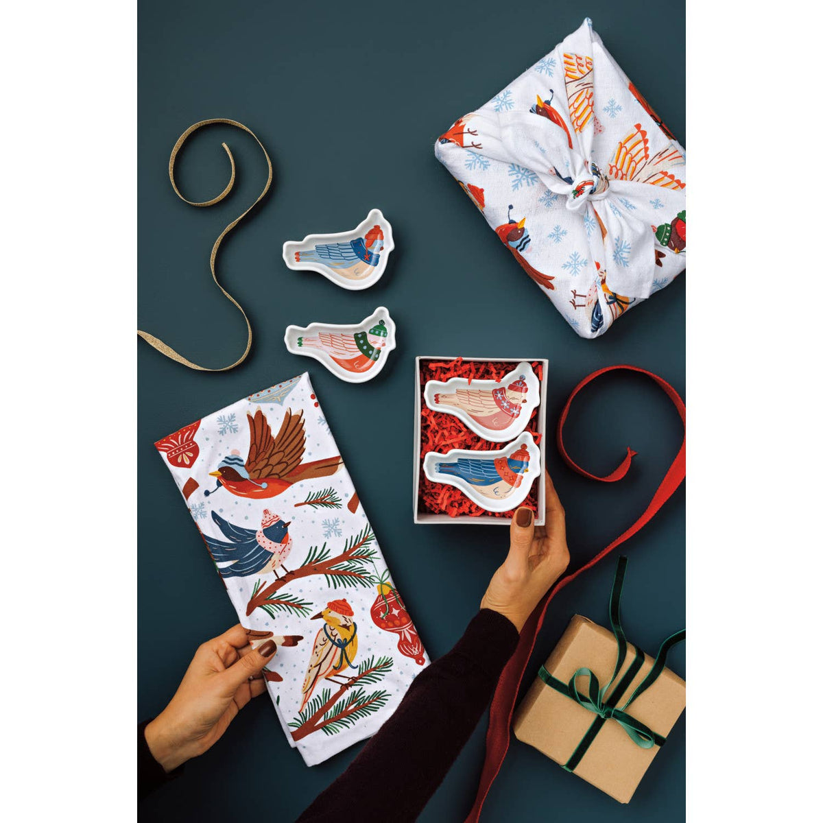 Bird-shaped mini dishes on ribbons attached to gift wrap and tags.
