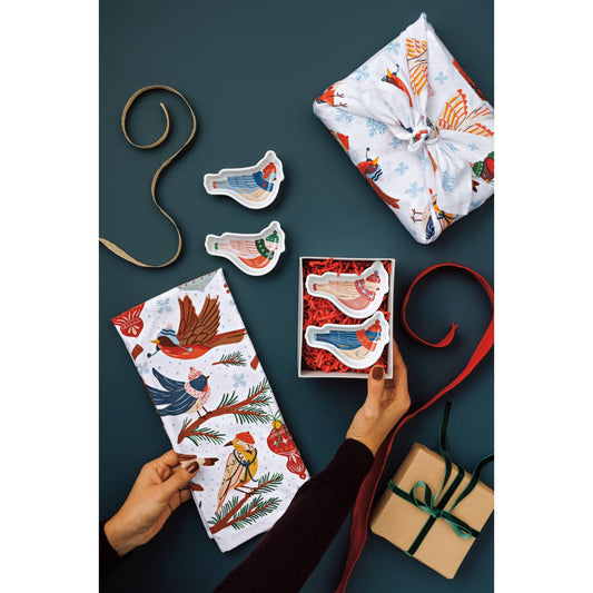 Bird-shaped mini dishes on ribbons attached to gift wrap and tags.