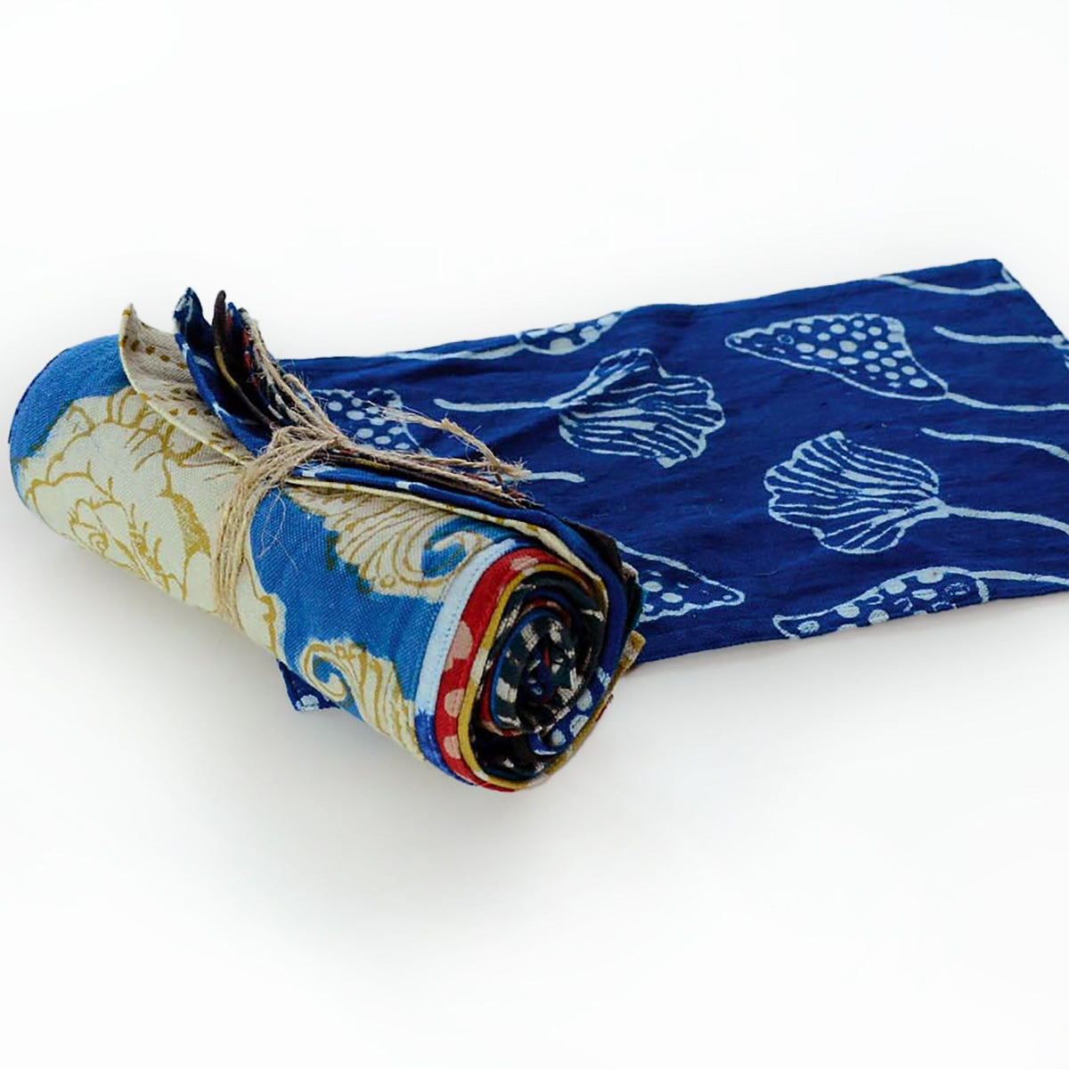 Rolled cotton towel bundle with blue patterned towels tied with twine