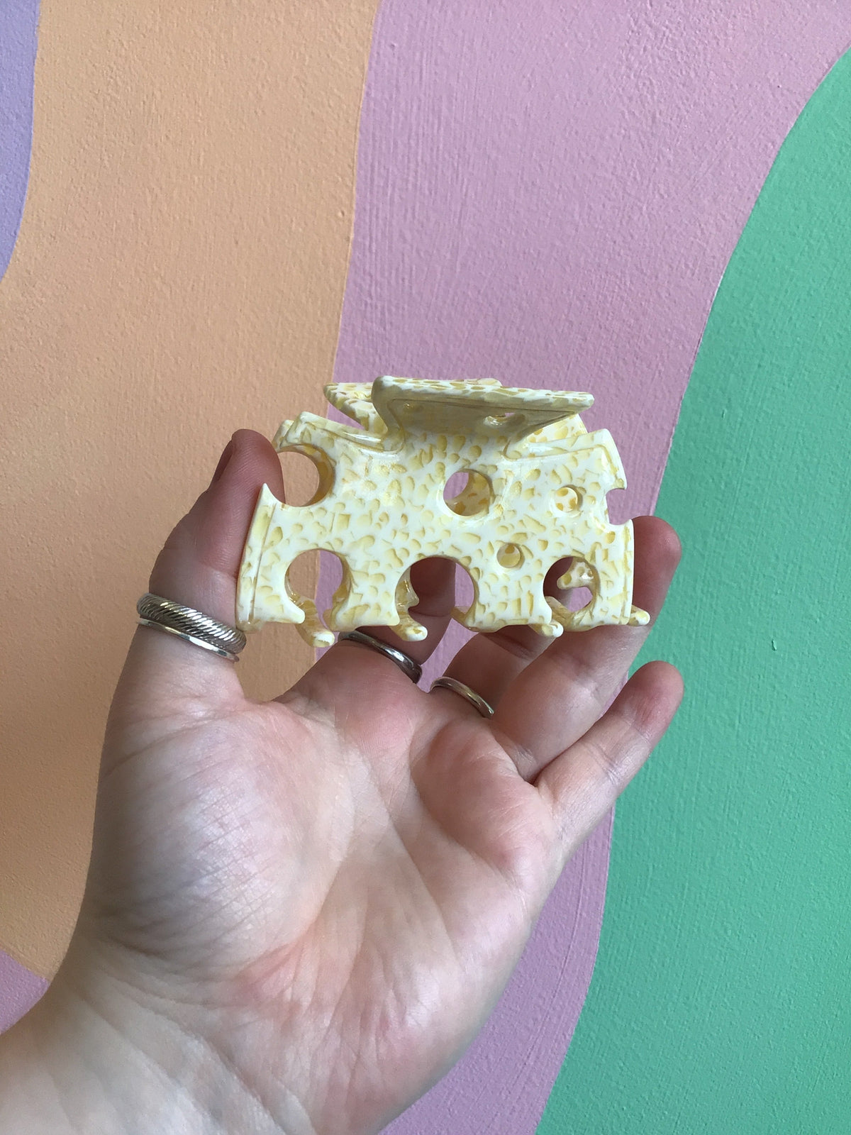 Cheese wedge-shaped hair claw in pale yellow with circular cutout details