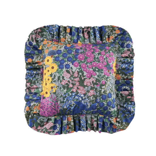 Floral ruffled pillow cover with patchwork front panel and gathered edge trim