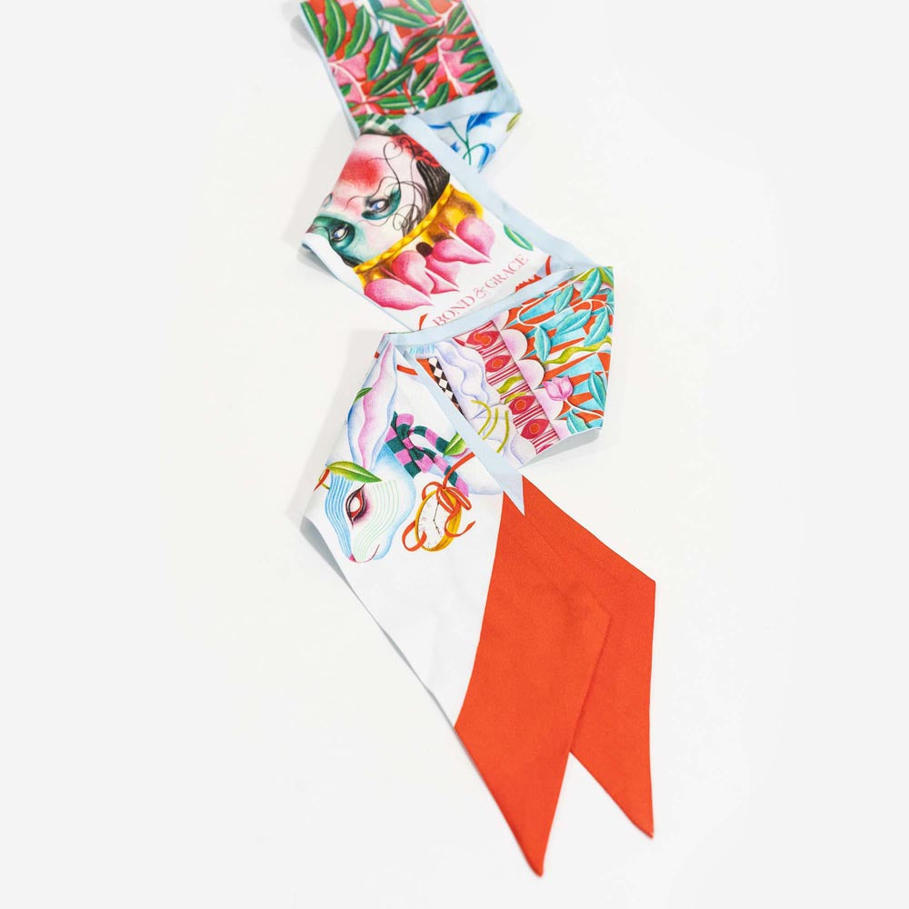 Silk twilly scarf with light blue bird-and-floral print and orange-red tail tips