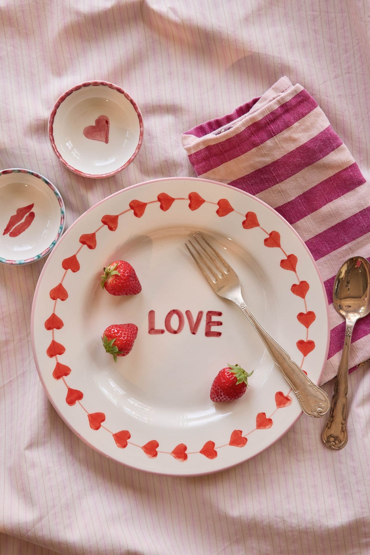 Ceramic dinner plate with hearts border and red LOVE, shallow bowl shape