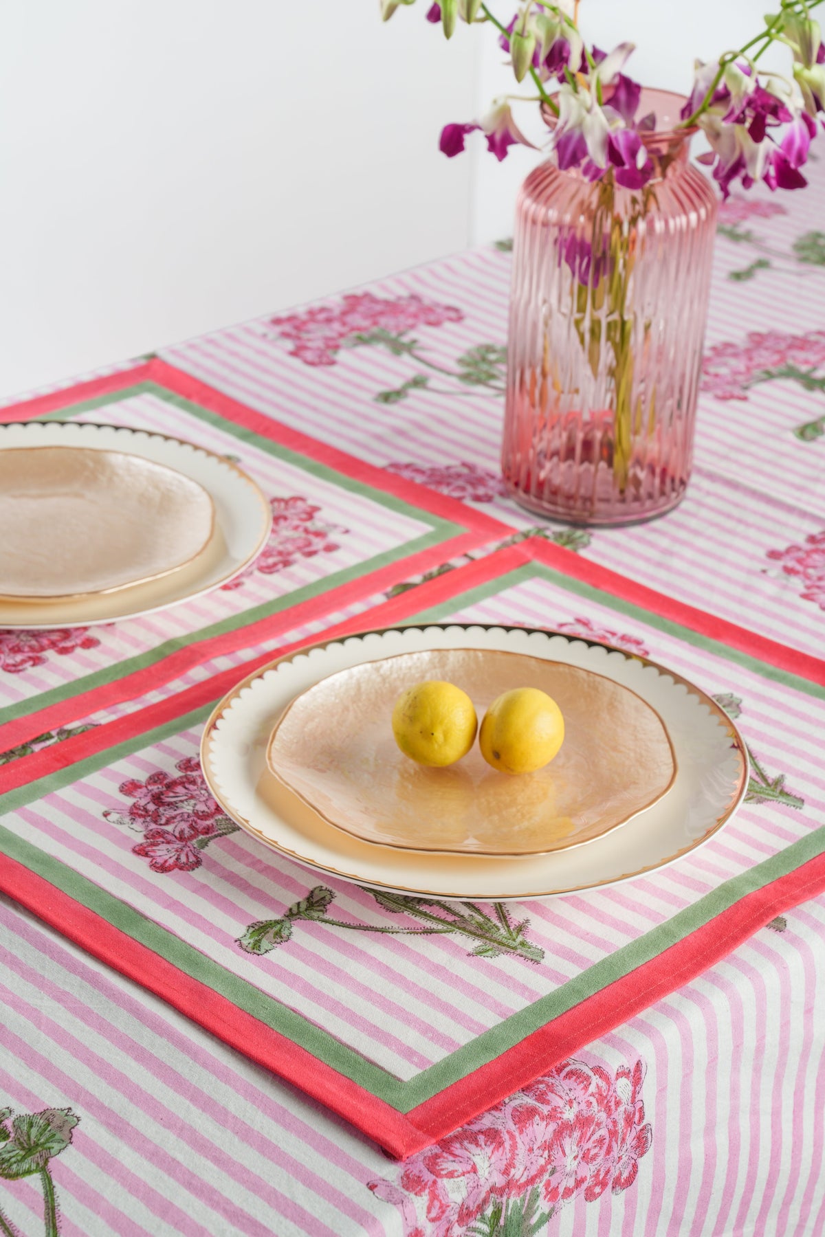 Pink hydrangea placemat set with red and green trim, striped background, rectangular shape