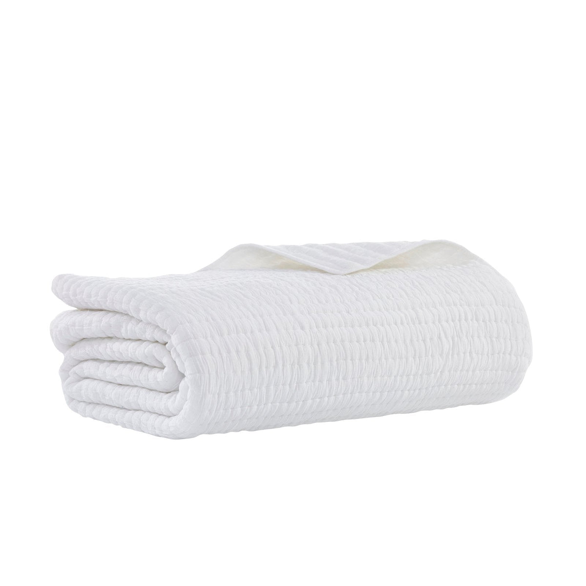White cotton quilt folded stack, crinkled quilted surface texture