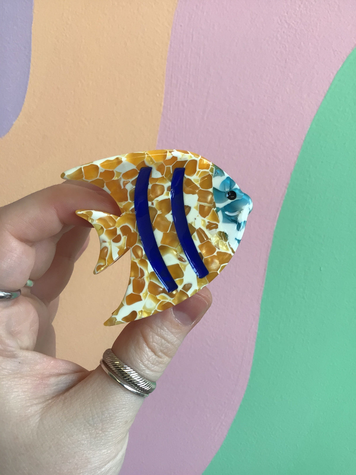 Ocean-themed hair claw with blue-and-gold spotted fish detail