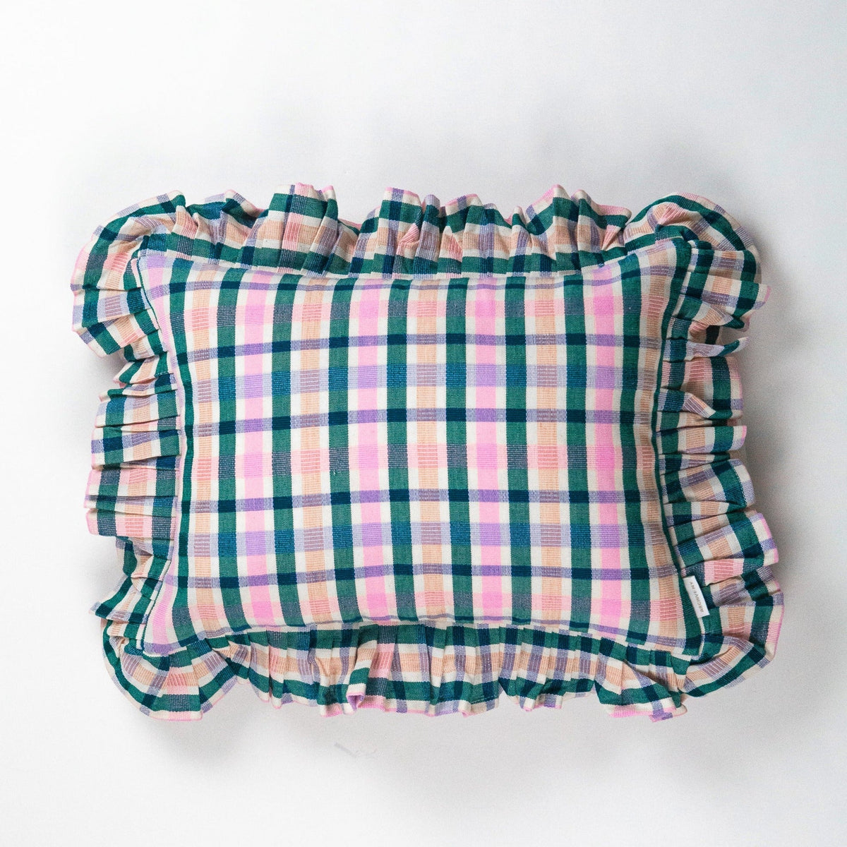Front view of colorful plaid ruffle pillow with gathered edges