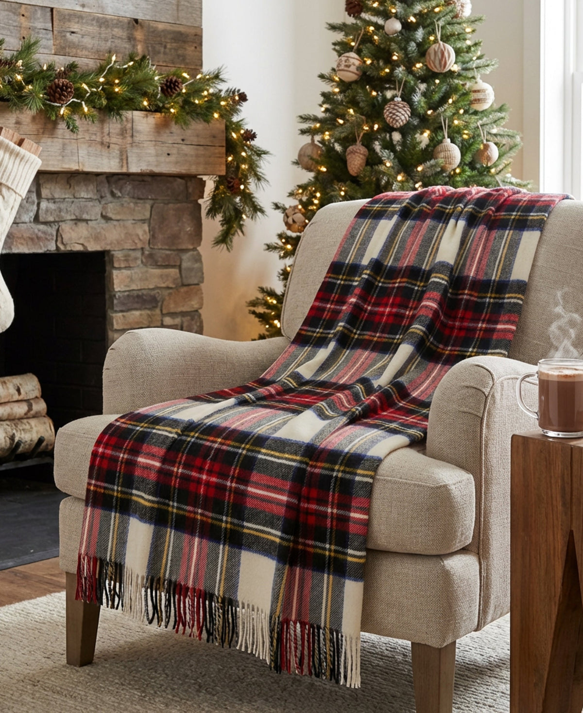 Plaid throw blanket draped over a chair arm in cream, red, black, blue, and fringe.