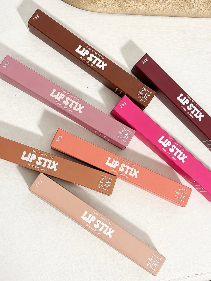 Assorted lip liner pencils with colored cases in multiple mauve, coral, and brown shades.