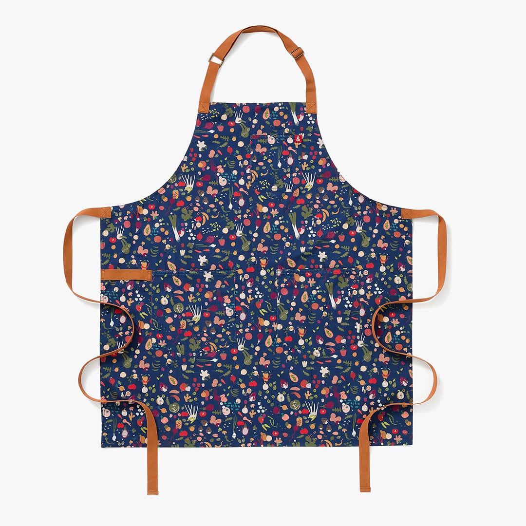 Navy floral cotton apron with tan straps and front ties, includes two front pockets