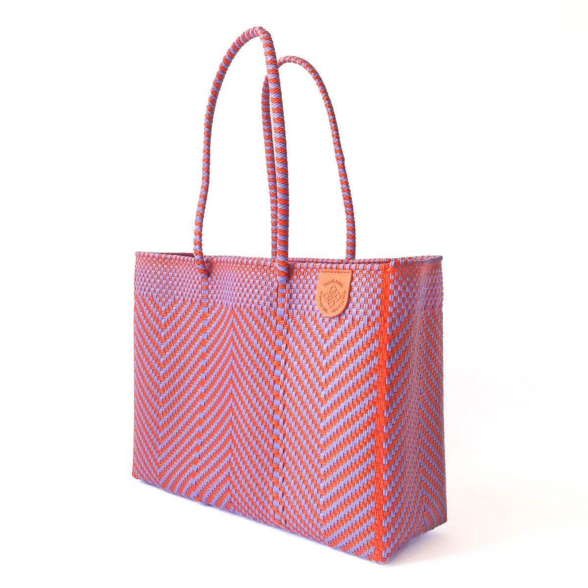 Chevron woven tote with rope handles and orange leather patch, side view
