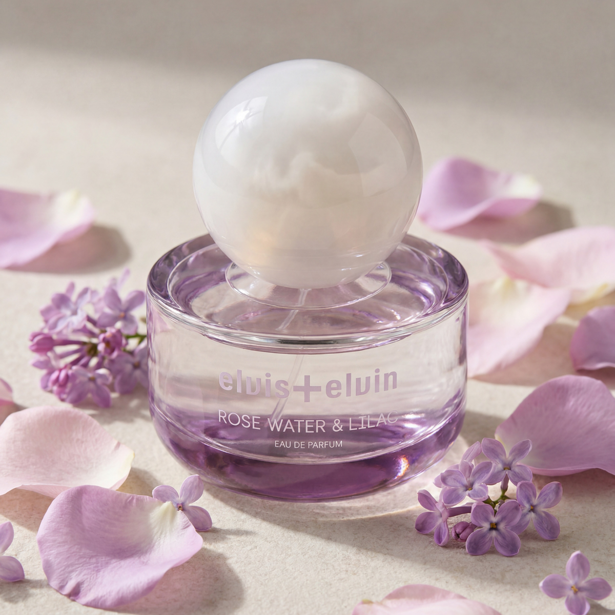 elvis+elvin Rose Water & Lilac eau de parfum bottle with rose and lilac petals