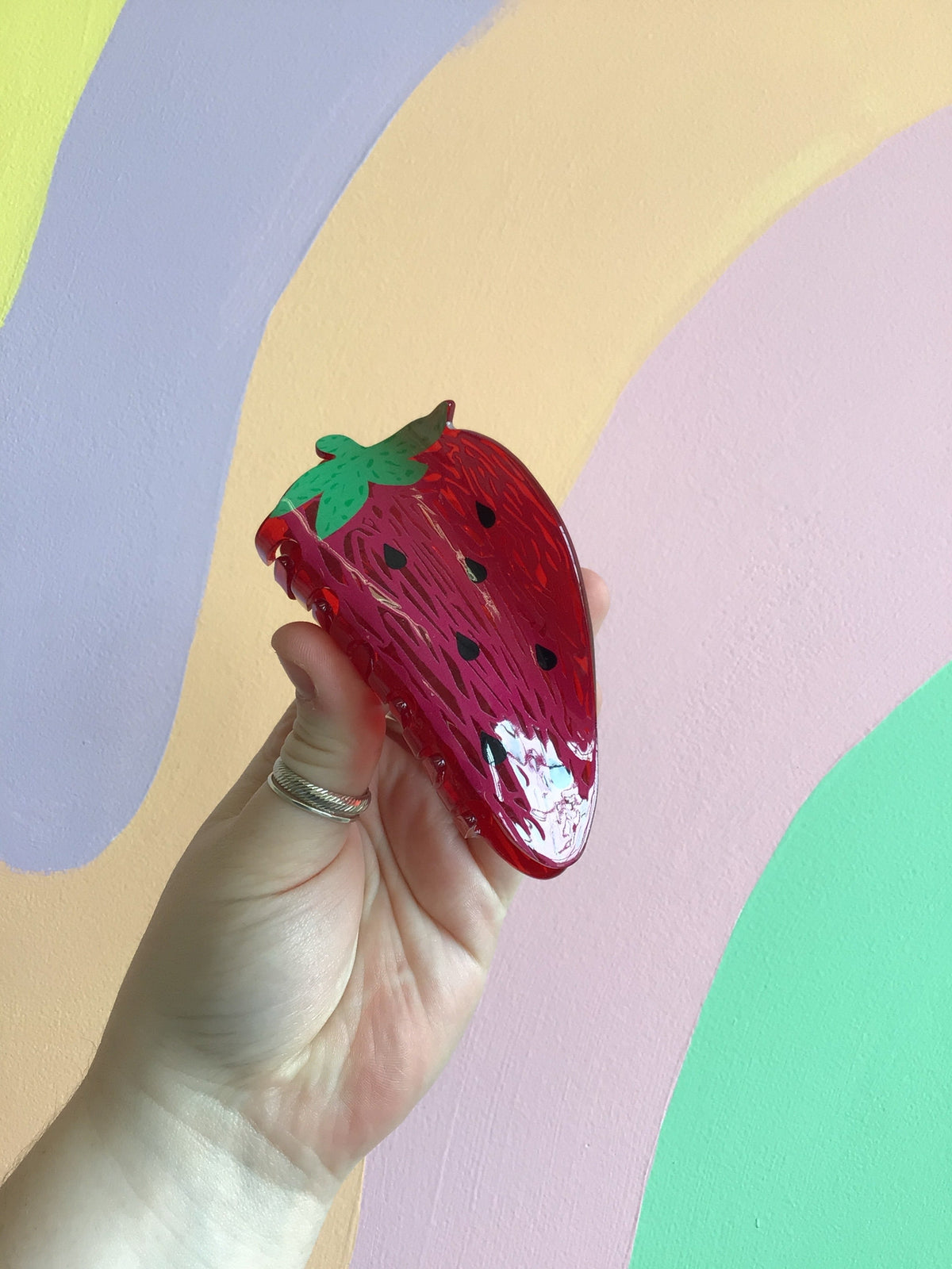 Red strawberry food hair claw with green leafy top detail