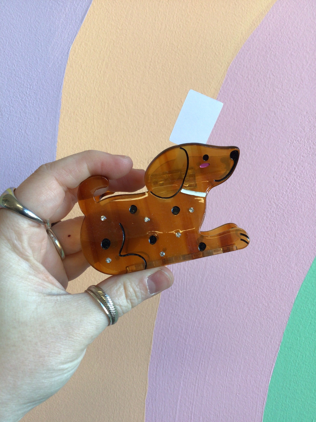 Amber animal hair claw with dark spots and cute cartoon face detail