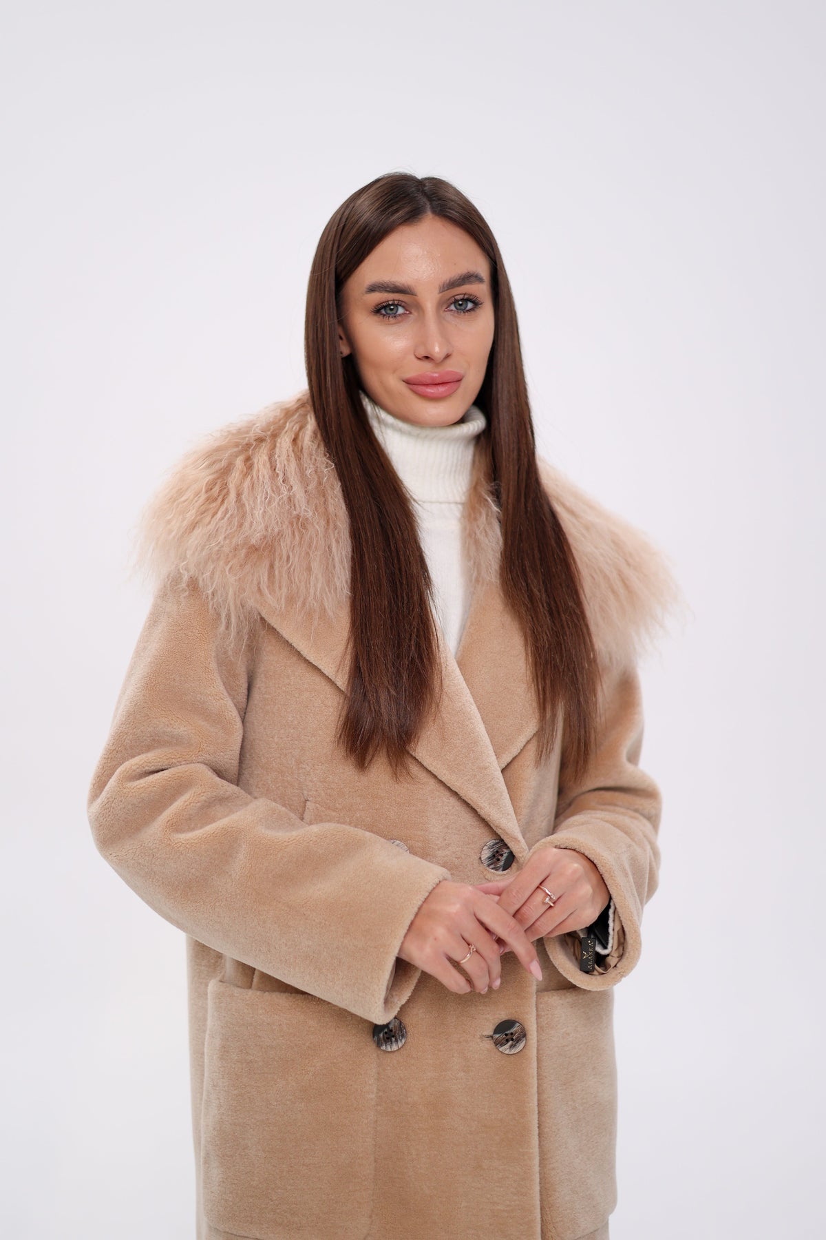 Beige coat with wide lapels, shaggy fur collar, and dark buttons