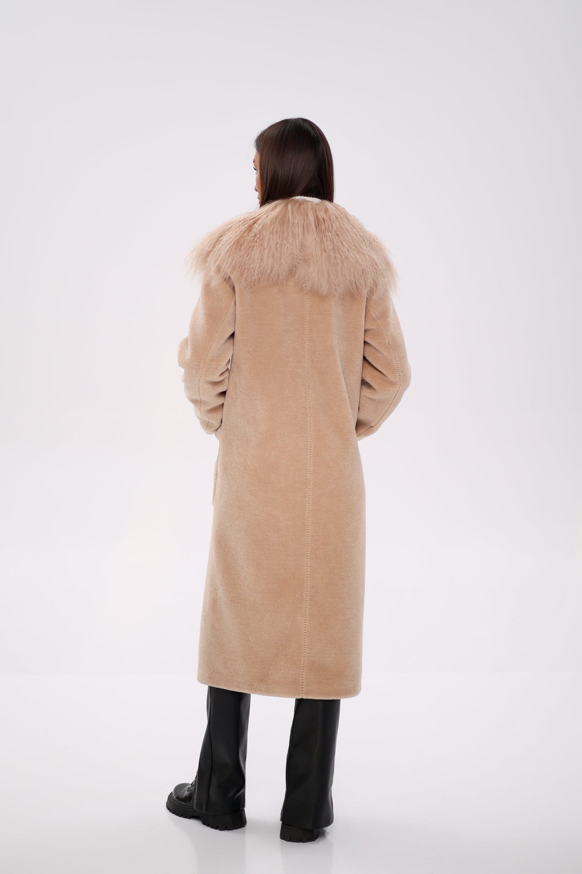 Rear view of a long beige coat with a shaggy fur collar