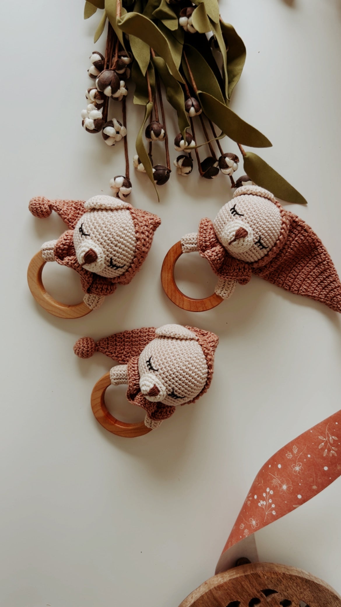Knitted teddy bear teether rattles with wooden rings, brown and beige faces, set of three