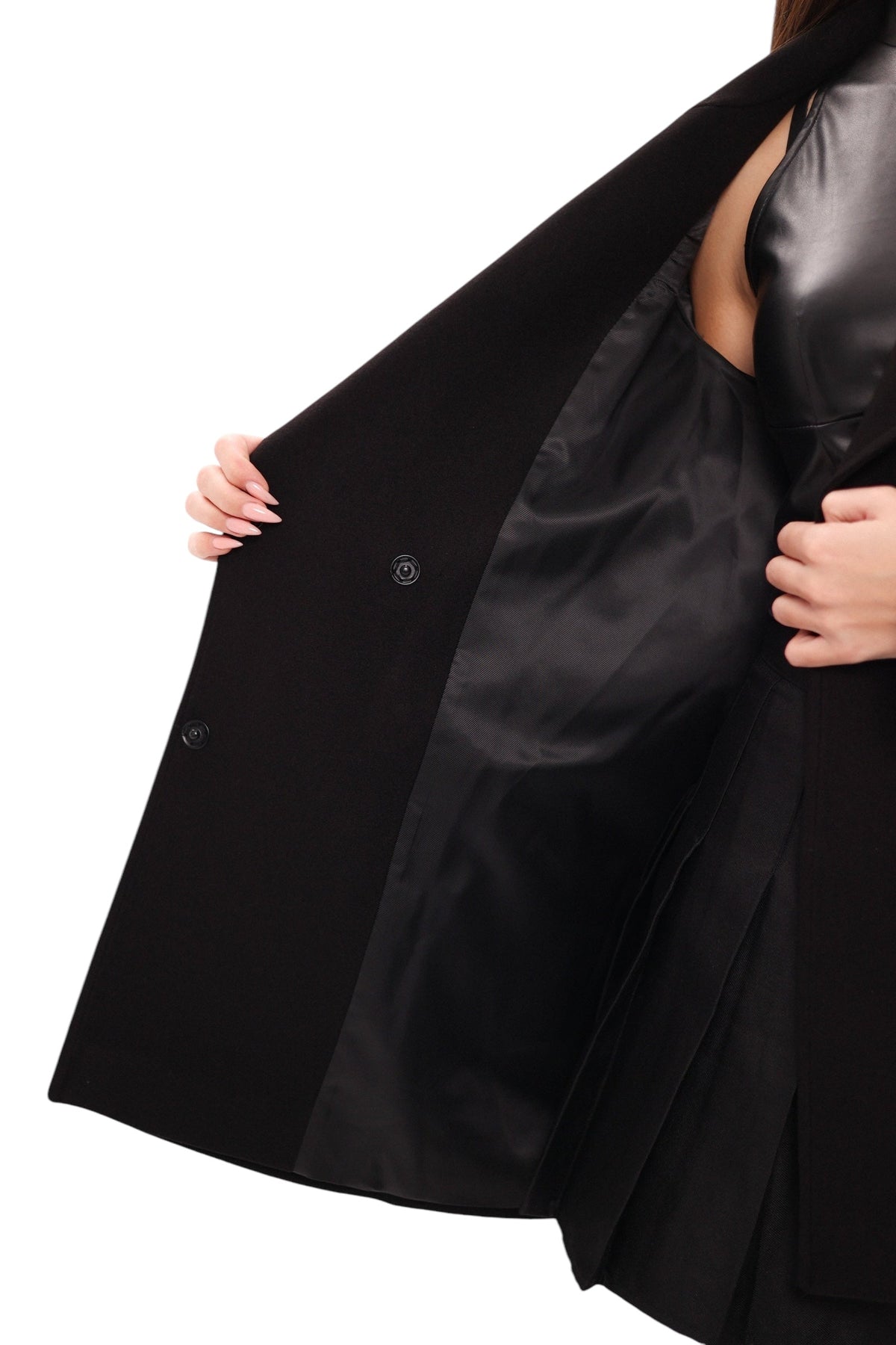 Black midi coat opened to show its smooth dark lining and front buttons