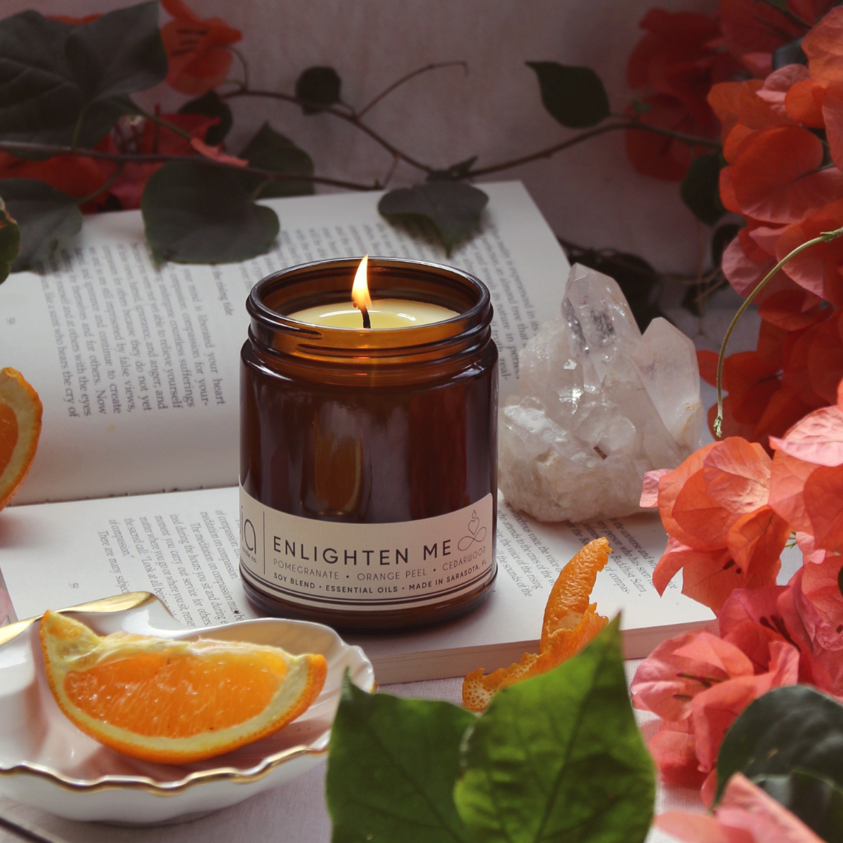 Amber glass jar soy candle with flame and white ENLIGHTEN ME label