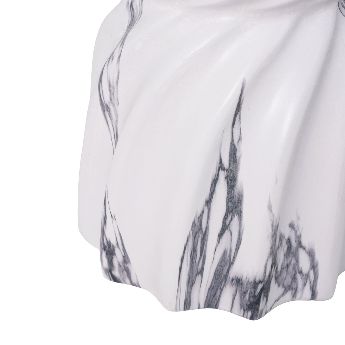 Close-up of the side table's sculpted white surface and gray veining