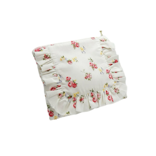 White floral ruffle zipper pouch with gathered front and brass zipper pull
