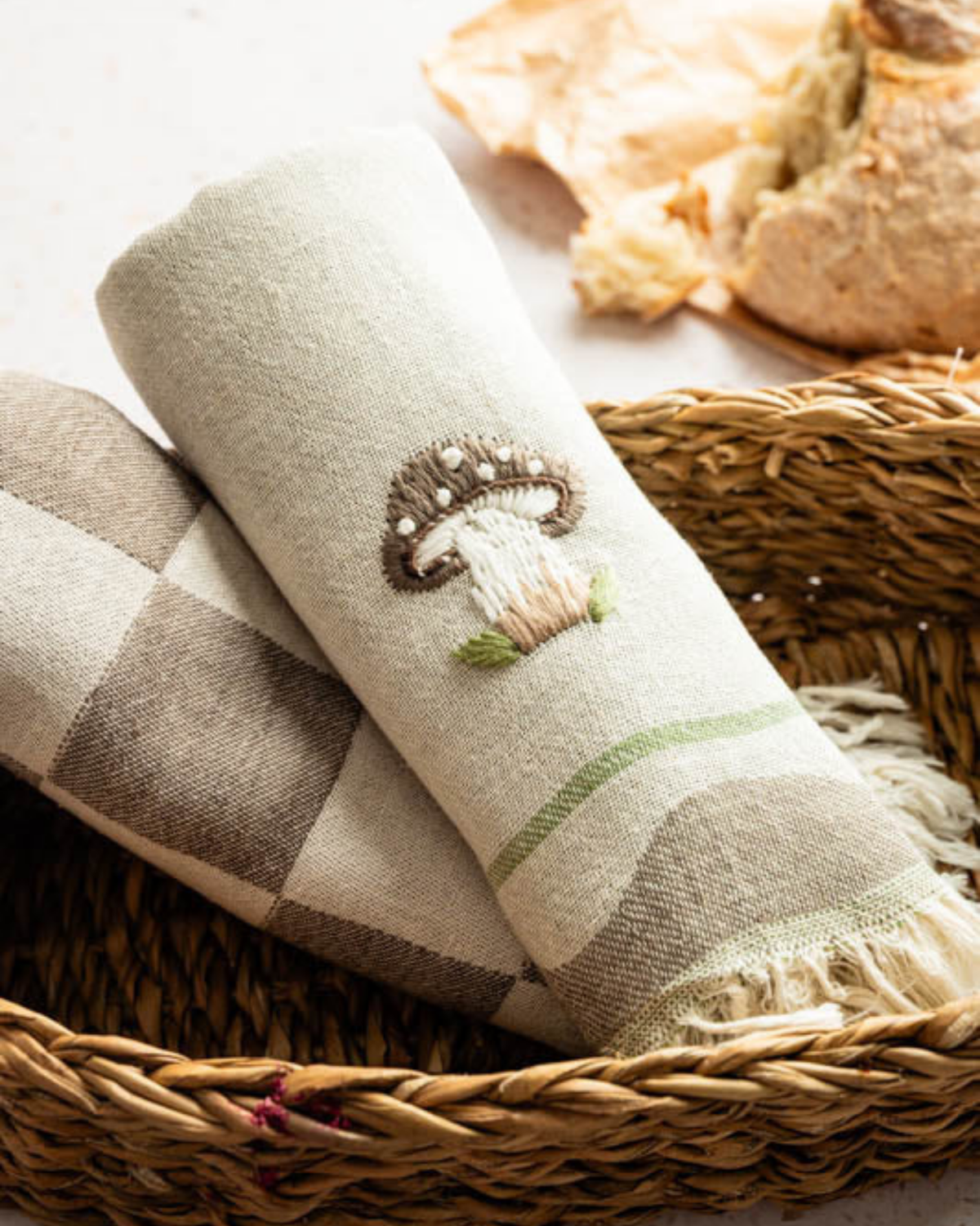 Tea towel with embroidered mushroom on beige plaid, fringed hem and green stripe