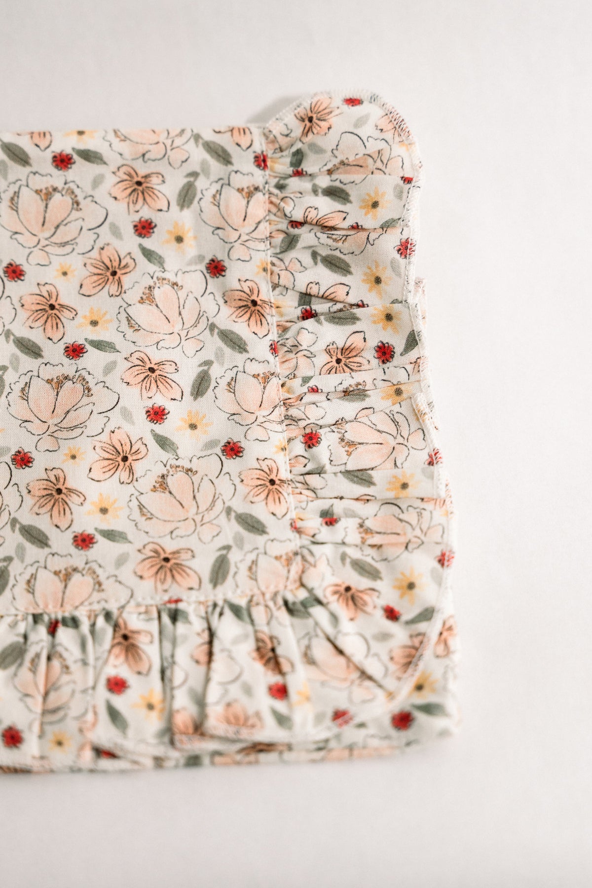 Primrose Garden floral ruffle zipper pouch closeup, cream with Petite Bouquet print