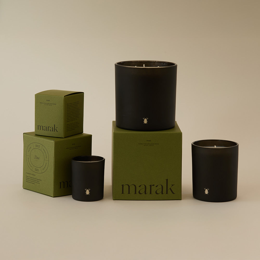 Marak candle set: black jar candle on green box with two smaller black jars