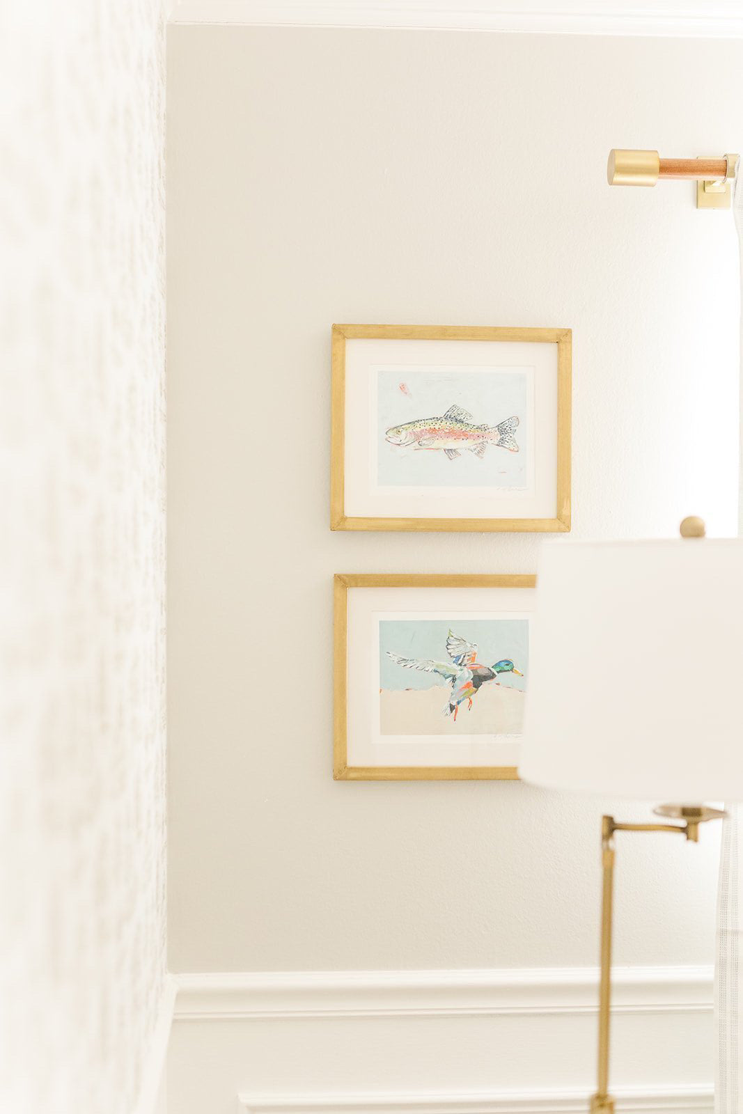 Two gold-framed fine art prints showing a mallard duck and a fish