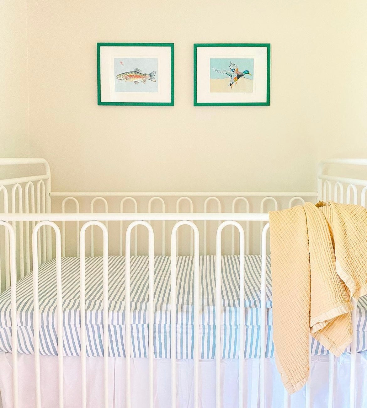 Two small teal-framed wall prints with a mallard duck and fish artwork