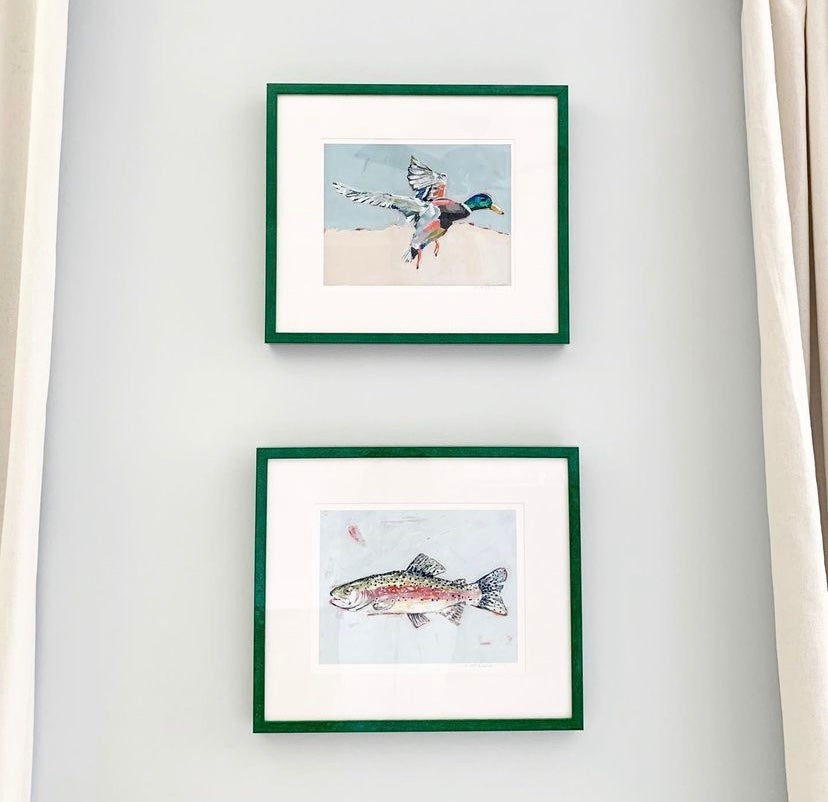 Two green-matte framed prints featuring a mallard duck and a fish
