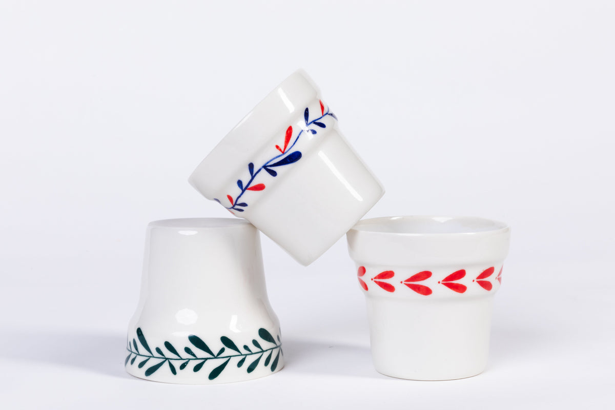 Ceramic espresso cup pair with red leaf and blue floral designs